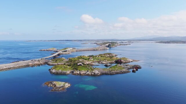 Aerial drone view of the Atlantic Ocean Road in Norway. Winding highway bridge connecting islands across rough ocean waves during a scenic coastal road trip.