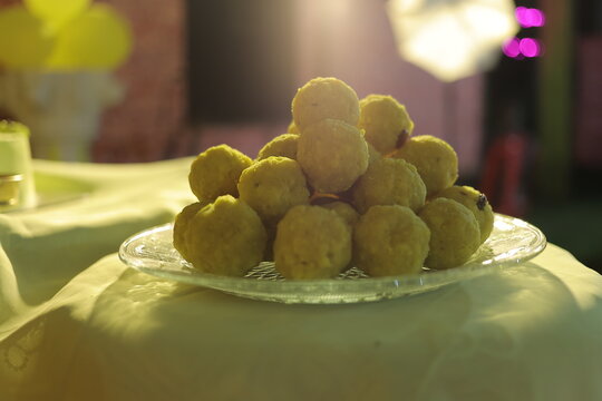 Fresh traditional Indian sweet yellow besan laddoo stacked on a plate for festival celebration