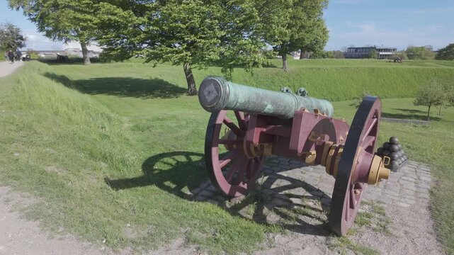 Slow motion bronze cannon on a red gun carriage, Kastellet