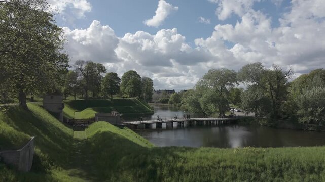 Slow motion clouds above the Kastellet moat and footbridge