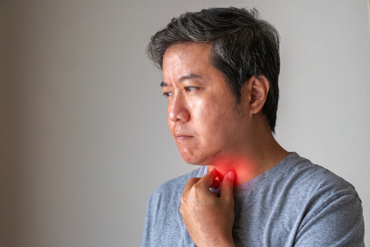 Person using red light therapy on throat, illustrating sore throat and bronchial disorders for medical treatment concept.