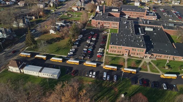 Aerial view of yellow school buses outside an American public school in the United States