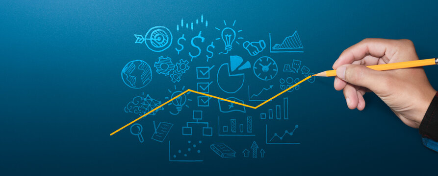 Businessman hand holding pencil drawing upward growing trend line over business strategy icons on blue background