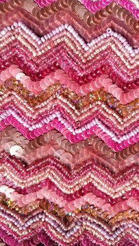 Pink sequin and bead embroidery texture background