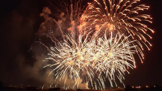 Vibrant fireworks display illuminating night sky over city skyline