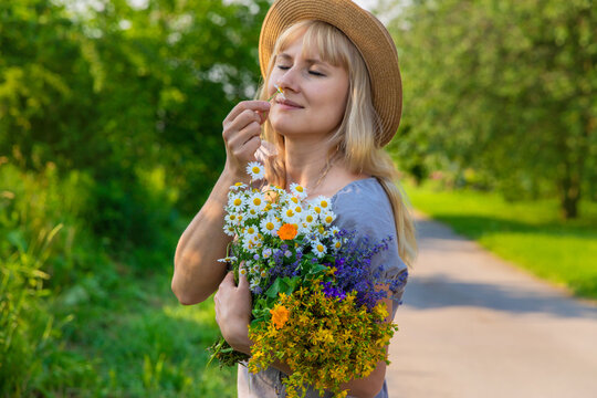 Woman with medicinal herbs. Selective focus.
