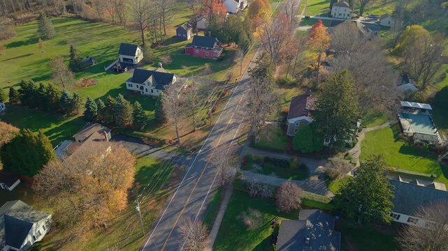 Aerial view of suburban neighborhood and residential road in the United States during autumn