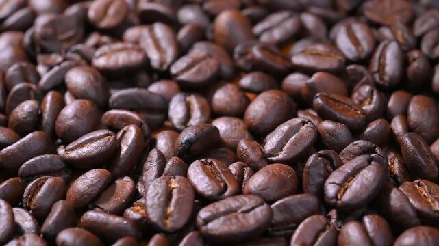 Close-up of premium roasted coffee beans with rich brown color and natural texture. Fresh aromatic coffee beans suitable for coffee, caf&eacute;, beverage, roasting, caffeine, and food background concepts.