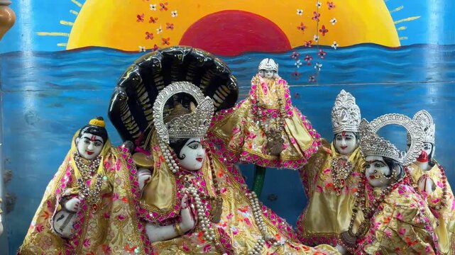 Beautifully decorated idols of Radha and Krishna displayed before an artistic devotional backdrop, representing divine love, spiritual harmony, and timeless Hindu traditions.
