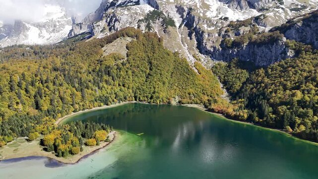 Aerial pan up and forward flight over rugged Mount Maglic peak and Dinaric Alps