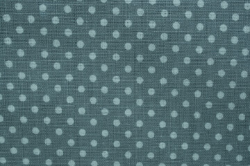 Fabric background showing a blue textile with repeating white polka dots design © Floren Horcajo