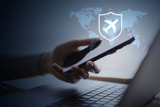 Online airline booking on smartphone with airplane shield, digital world map and laptop for secure business travel technology concept.