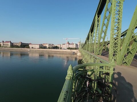 Low water level of the Danube river in Budapest at sunrise, featuring the Liberty Bridge and the uncovered Inseg Rock, and the Margit bridge and the island. 02.08.2026.
