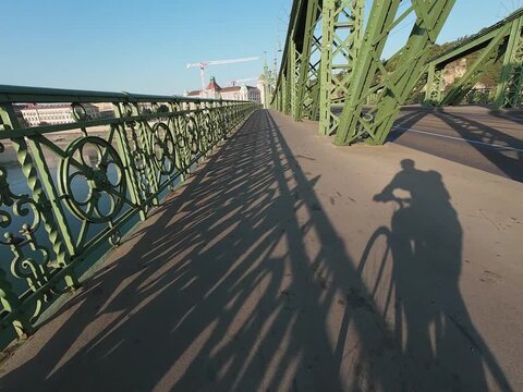 Low water level of the Danube river in Budapest at sunrise, featuring the Liberty Bridge and the uncovered Inseg Rock, and the Margit bridge and the island. 02.08.2026.