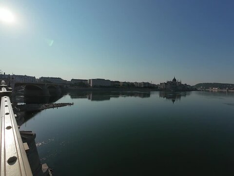Low water level of the Danube river in Budapest at sunrise, featuring the Liberty Bridge and the uncovered Inseg Rock, and the Margit bridge and the island. 02.08.2026.