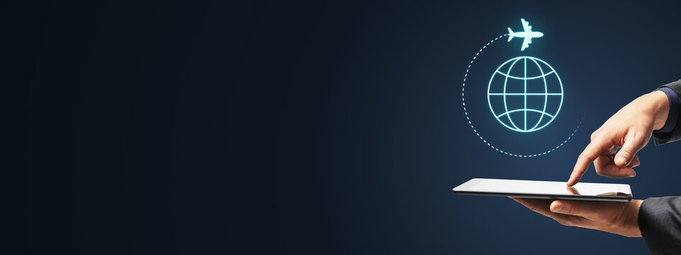Global travel technology concept with hand using tablet, glowing airplane and digital globe on dark blue background with creative copy space design.