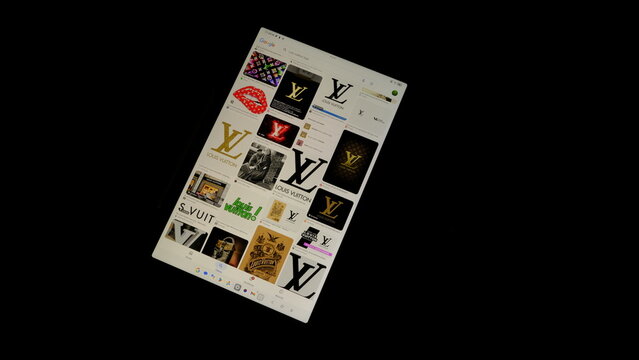 Tablet screen view with various sized Louis Vuitton logos, on a black background, August 1, 2026	
