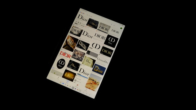 Tablet screen view with various sized Dior logos, on a black background, August 1, 2026