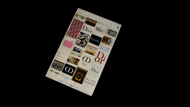 Tablet screen view with various sized Dior logos, on a black background, August 1, 2026