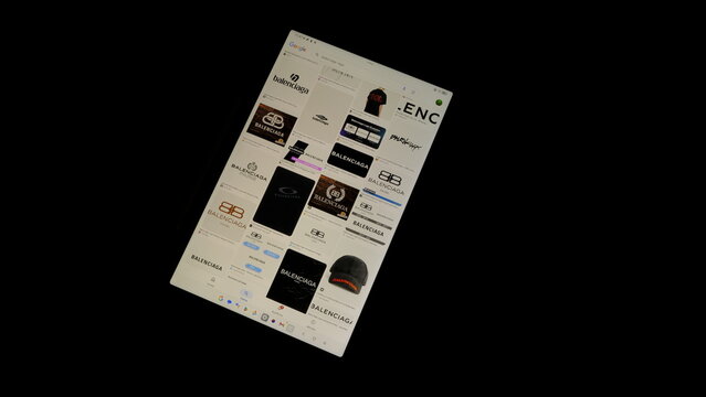 Tablet screen view with various sized Balenciaga logos, on a black background, August 1, 2026