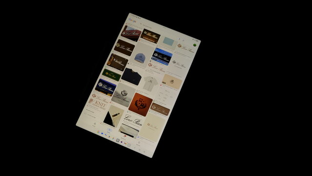Tablet screen view with various sized Loro Piana logos, on a black background, August 1, 2026
