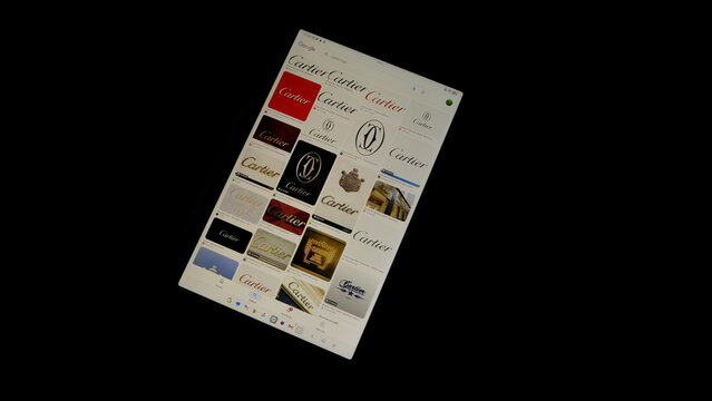 Tablet screen view with various sized Cartier logos, on a black background, August 1, 2026