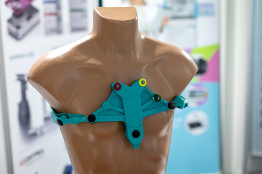 Turquoise Sensor Harness Displayed on a Torso Mannequin. Turquoise adjustable sensor harness fitted around a torso mannequin at a medical technology display.