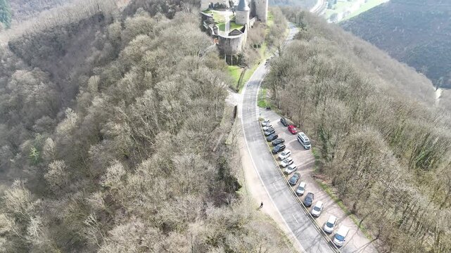 Cinematic drone flyover and forward approach over stone ruins of Bourscheid Castle