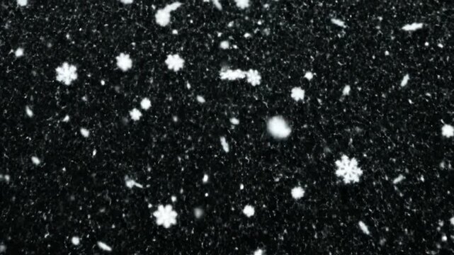 White snowflakes falling on a black background