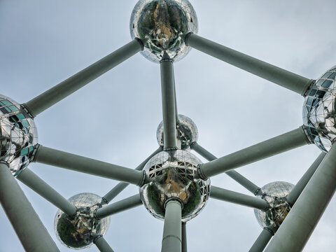 Brussels, Belgium. April 18, 2026, Atomium landmark structure with reflective spheres and connecting tubes, symbolizing an iron crystal against a cloudy sky