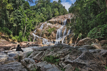 Multi-tier cascade of Sungai Pandan Waterfalls in lush Malaysian jungle © mgHasim 