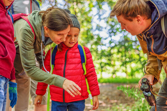 White family exploring nature with young child and man outdoors