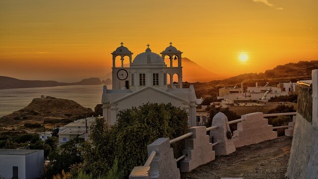 Church, orthodox, Greek Orthodox church, Agios Nikolaos church, a church appears against an orange sunset with sea view and mountains, Trypiti, Tripiti, village, Milos, island, Cyclades, Greek islands, Greece