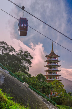 Genting Highlands, Malaysia - February 22, 2025: A view of the Awana SkyWay cable car passing above the Chin Swee Caves Temple in the mountainous resort area of Malaysia