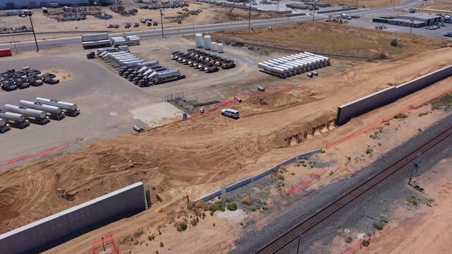 Still Aerial Drone Shot Over Train Track With California High Speed Rail Construction Intrusion Barrier Walls and Orange Safety Netting in Fresno California