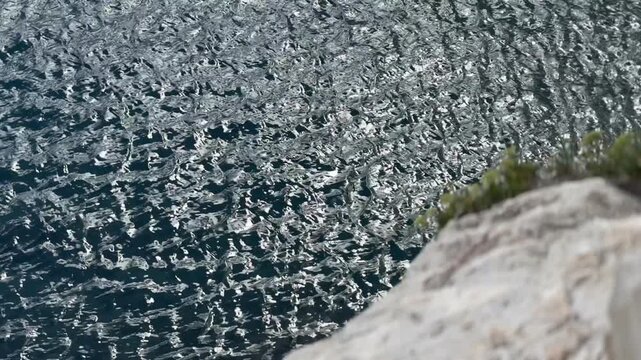 Split, Croatia - October 07, 2025: Clear water reveals rocky underwater landscape with visible stones and pebbles, showcasing the natural beauty of the coastal environment