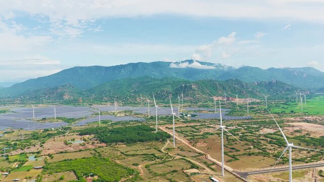 Aerial view of Dam Nai Wind Farm with mountains and solar farm in Khanh Hoa, Vietnam