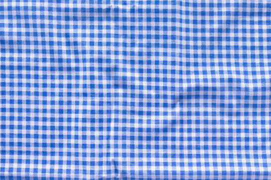 Crumpled blue gingham fabric close up
