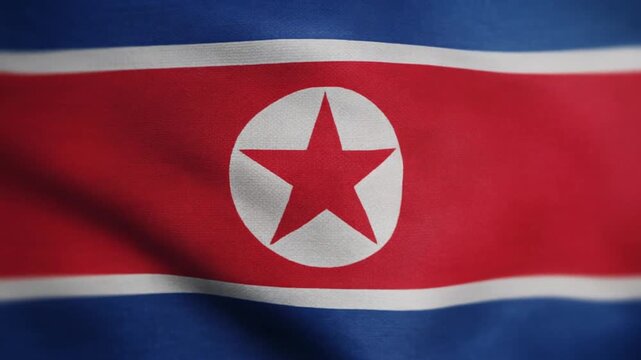 Close-up of North Korean flag fabric waving in wind, detailed textile texture video
