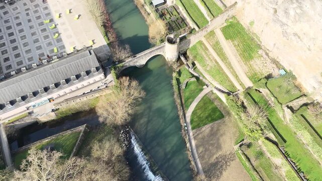 Birds eye view drone pan up from valley gardens revealing Eglise Saint Michel Luxembourg City