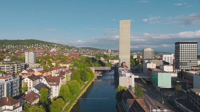 Aerial Drone View of Train Crossing Viaduct Over Limmat River with Swissmill Tower, Zurich West, Switzerland