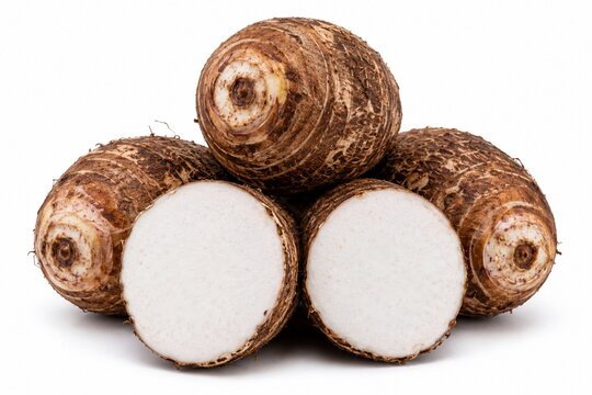Fresh whole and half-sliced taro roots isolated on a white background. Raw organic taro corms, healthy ingredient for cooking asian cuisine, snacks, and desserts.