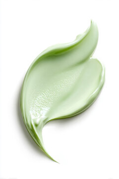 Green cosmetic cream swatch forming leaf shape, showing organic skincare product texture on white background