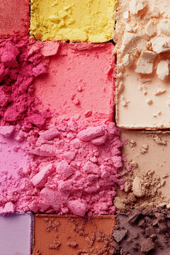 Colorful eyeshadow palette showing vibrant crushed pigments layering different cosmetic textures