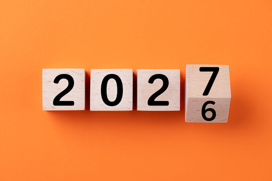 2027 Happy New Year. Wooden cube block change from 2026 to 2027. Concept 2027 New Year background. Business, resolutions, goals, inspiration, success, ideas