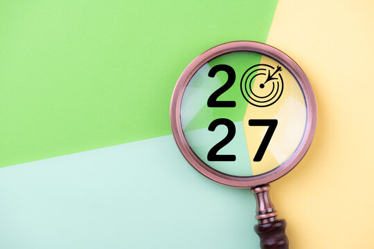 2027 New Year card. New Years goals 2027 with magnifying glass, target icon. Concept 2027 New Year background. Business, resolutions, goals, inspiration, financial, success, ideas