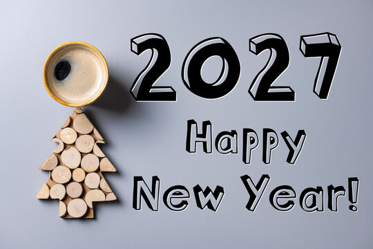 2027 Happy New Year card. Creative wooden New Year tree and coffee cup. New Year eco frienly card. Sustainable lifestyle, plastic free holidays concept. Nature New Year concept