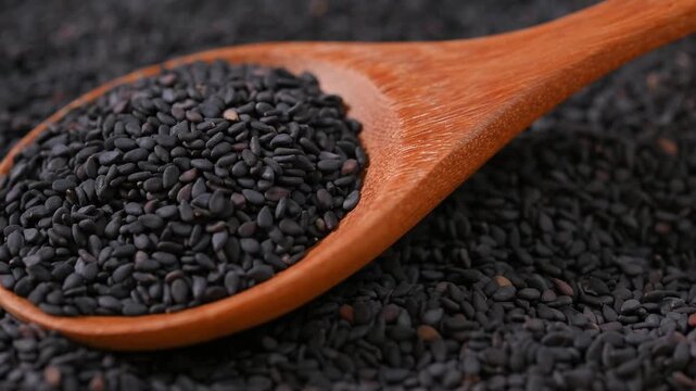 Black Sesame Seeds in Wooden Spoon	
