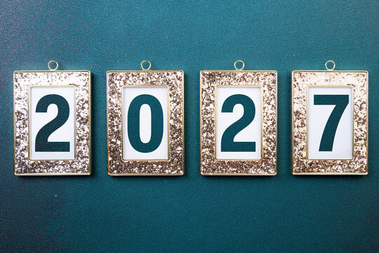 2027 Happy New Year. 2027 in golden frame on green background. Festive concept 2027 New Year. New Year resolutions, celebrate, greeting card