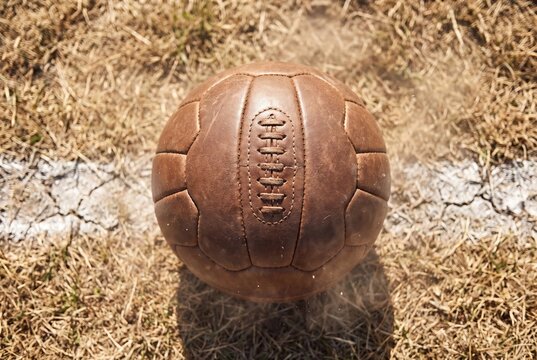 Vintage leather football on grass field closeup sport retro design